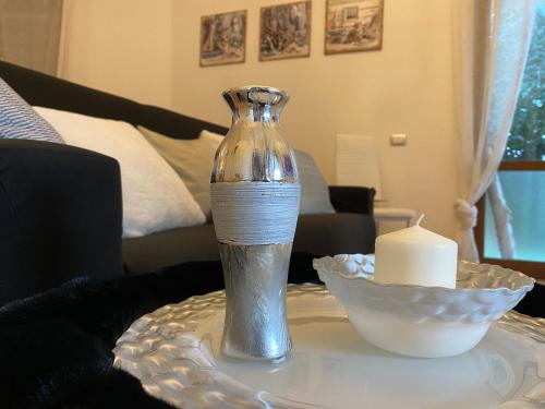 a glass vase sitting on a table with a candle at Villa Bianca in Tertenìa