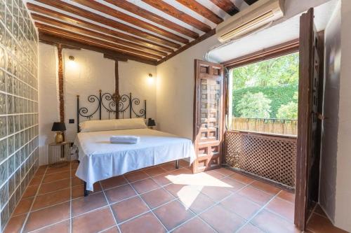 a bedroom with a bed and a large window at Encantador apartamento en Calle Segovia in Madrid