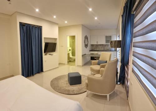 a bedroom with a bed and a living room at Byblos Prime in Aqaba