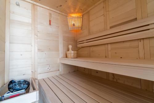 a sauna with wooden paneling and a chandelier at Corfu Maris in Benitses