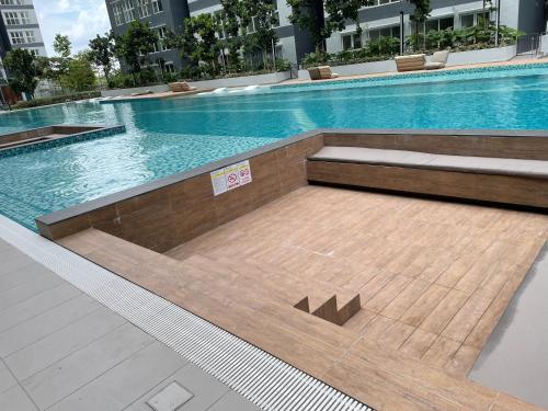 a large swimming pool in a building with a sign on it at Has Hills Residence - 2 BEDROOMS CONDO with WiFi in Kajang