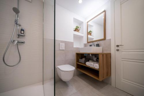 a bathroom with a toilet and a sink and a shower at House Leska in Kranjska Gora