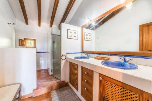 a bathroom with two sinks and a shower at Cas Galgo luxury Villa in Valldemossa in Valldemossa