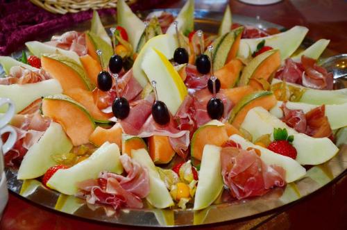 a plate of food with fruit on a table at Hotel-Pension Waldeck in Todtmoos