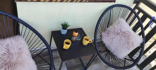 two chairs and a table on a balcony at Apartman Stefan Zlatibor in Zlatibor