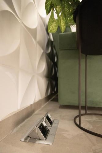 a drain in the floor in a room with a plant at BillMar Luxury Apartment in the center of Gythio in Gythio