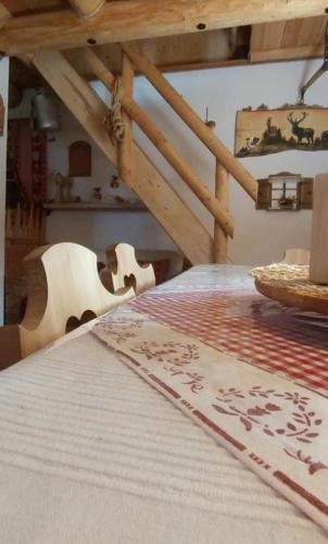 a table with a table cloth on top of it at Baita del Nonno dei Pitoi in Bedollo