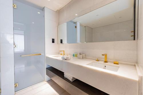 a bathroom with a sink and a mirror at Beautiful 2BR High-Floor Marina View in Five in Dubai