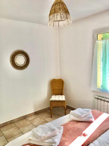 a room with a bed and a chair and a lamp at Domaine Plan des Devens in Roussillon