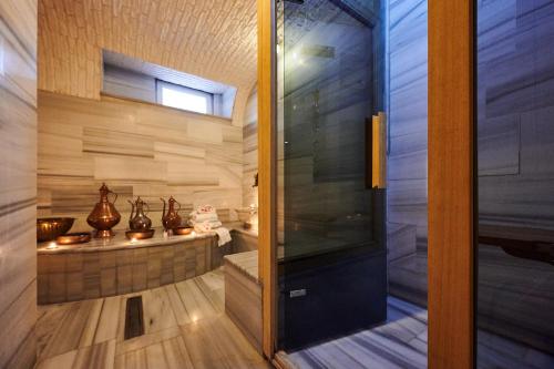 a glass door leading into a bathroom with a tub at Faik Pasha Hotels Special Category Beyoglu Istanbul in Istanbul
