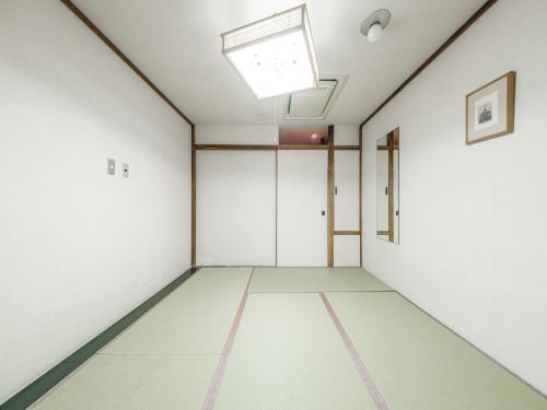 an empty room with white walls and a skylight at Tabist THE GREEN OTARU in Otaru