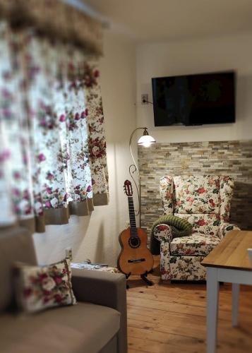 a living room with a guitar and a couch at Slnečný dom in Liptovské Revúce