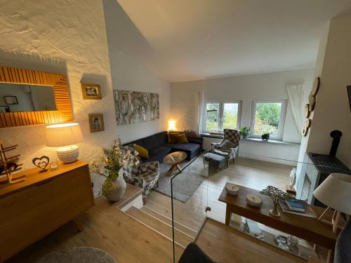a living room with a couch and a table at Eifelhäuschen am See in Biersdorf