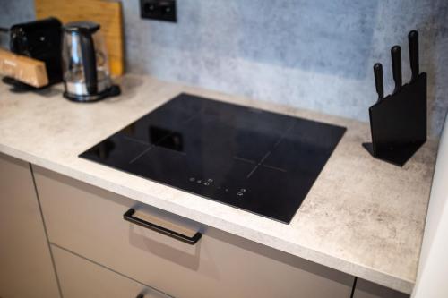 a kitchen counter with a black sink on it at Villapark in Rotterdam