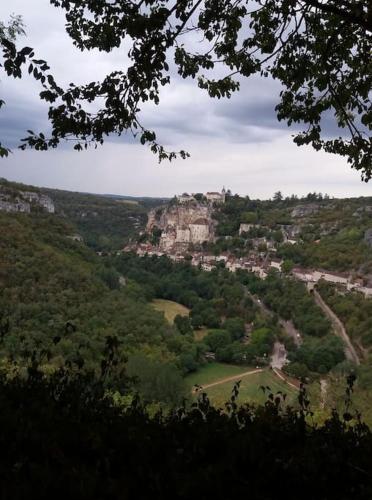 a view of a hill with a castle in the distance at Gîtes des Deux Vallées La Borieta du Causse - Rocamadour in Rocamadour