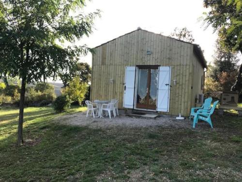 a shed with a table and chairs in a yard at Gîtes des Deux Vallées La Borieta du Causse - Rocamadour in Rocamadour