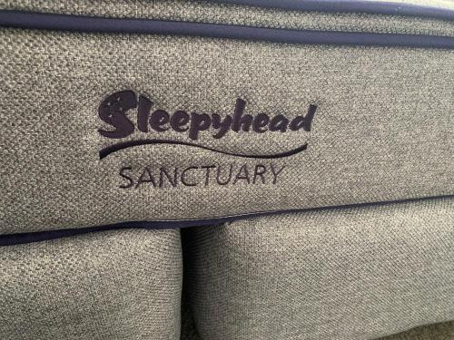 a close up of a sweater with the wordsselected saturday at 755 Regal Court Motel in Dunedin