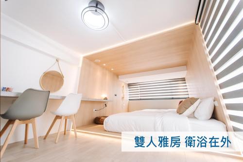 a bedroom with a bed and a staircase at AiMen Homestay in Huxi