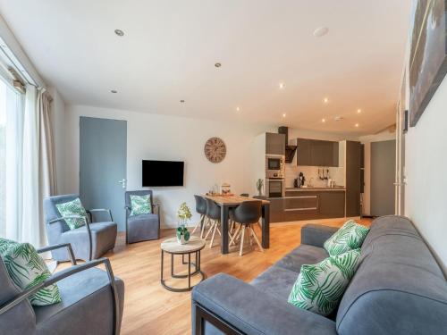 a living room with a couch and a table at holiday home in Goirle with sauna in Goirle