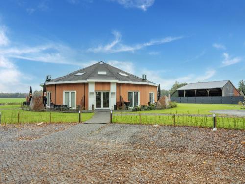 a house with a fence in front of it at holiday home in Goirle with sauna in Goirle