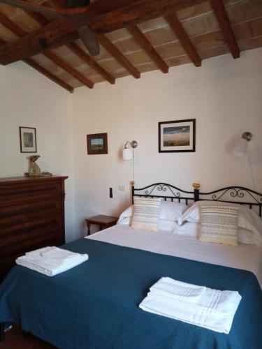 a bedroom with a bed with two towels on it at Tenuta della Selva in Murlo