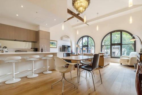 a kitchen and dining room with a table and chairs at The Sophia in Melbourne
