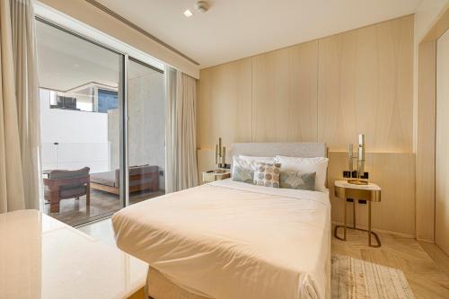 a bedroom with a large bed and a large window at Beautiful 2BR High-Floor Marina View in Five in Dubai