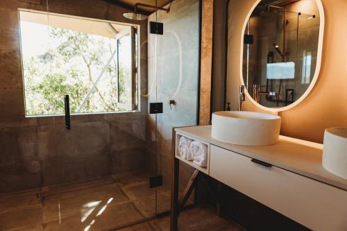 a bathroom with a sink and a mirror at Drift Off Grid Luxury Eco Glamping in Tarakohe