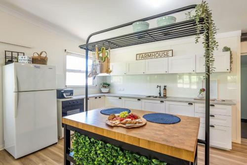a kitchen with a table with a plate of food on it at Sunshine Coast Farm Stay in Glass House Mountains
