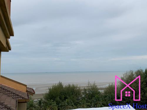 a pink picture of a house with the ocean in the background at Gold Coast Morib Resort in Banting