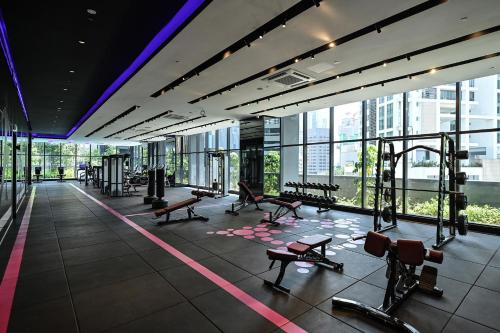 a gym with benches and equipment in a building at STAR RESIDENCE KLCC in Kuala Lumpur