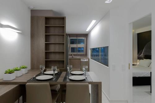 a dining room with a table and chairs and a bed at Acropolis Amazing Apartment with Parthenon view in Athens