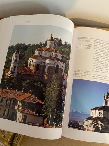 an open book with a picture of a building at Casa Maira in centro a Bra in Bra