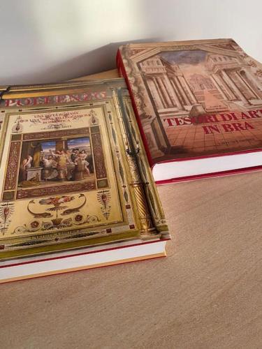 two books sitting on top of a table at Casa Maira in centro a Bra in Bra