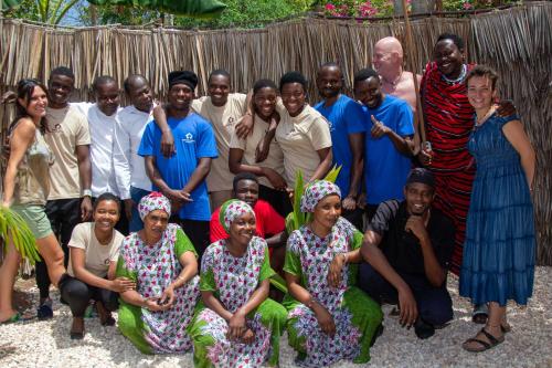 a group of people posing for a picture at Kibanda Lodge and Beach Club in Nungwi