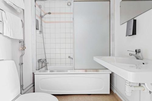 a white bathroom with a toilet and a sink at Best Western Hotell SoderH in Söderhamn