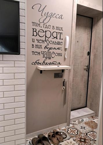 a bathroom with a door with a bunch of shoes on the floor at super apartment on O.Polya 137 in Dnipro