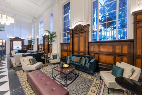 a lobby with a couch and chairs and a table at Adina Apartment Hotel Brisbane in Brisbane