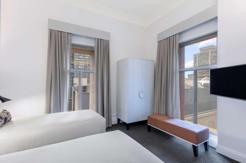 a hotel room with two beds and a large window at Adina Apartment Hotel Brisbane in Brisbane