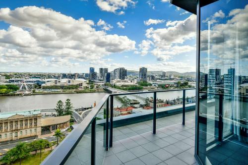a balcony with a view of a river and buildings at Adina Apartment Hotel Brisbane in Brisbane