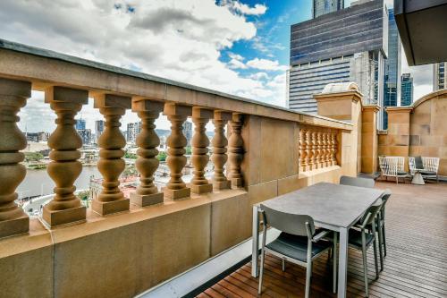 a balcony with a table and chairs on a building at Adina Apartment Hotel Brisbane in Brisbane