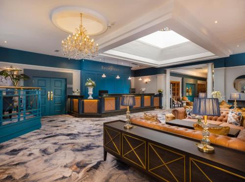 a living room with blue walls and a chandelier at Ardboyne Hotel in Navan