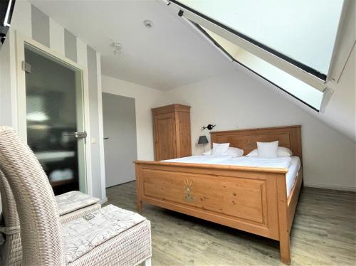 a bedroom with a bed and a chair in it at Hotel Wasserschloss Mellenthin in Mellenthin