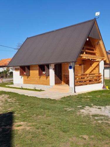 a large wooden building with a black roof at Kuća za odmor Antonija in Gospić