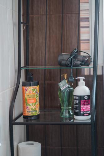 a shelf with toiletries on it in a bathroom at Ioanna's Hellenic Hospitality in Athens