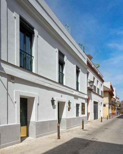 a white building on the side of a street at Hotel Boutique Triana House in Seville