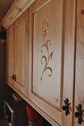 a wooden cabinet with a metal design on it at BIAŁY PUCH in Zakopane