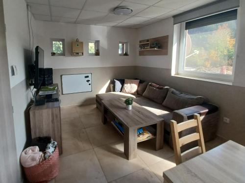 a living room with a couch and a table at Chata U dědka in Prostřední Bečva