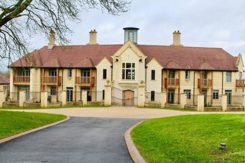 a large house with a driveway in front of it at The Chalet in Radstock