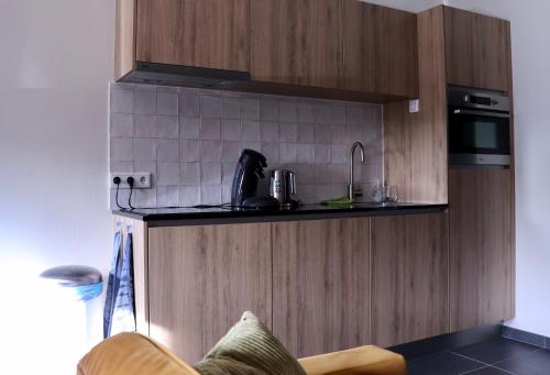 a kitchen with a sink and a stove top oven at WijkD in Leende